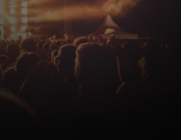 A festival crowd in front of a lit stage